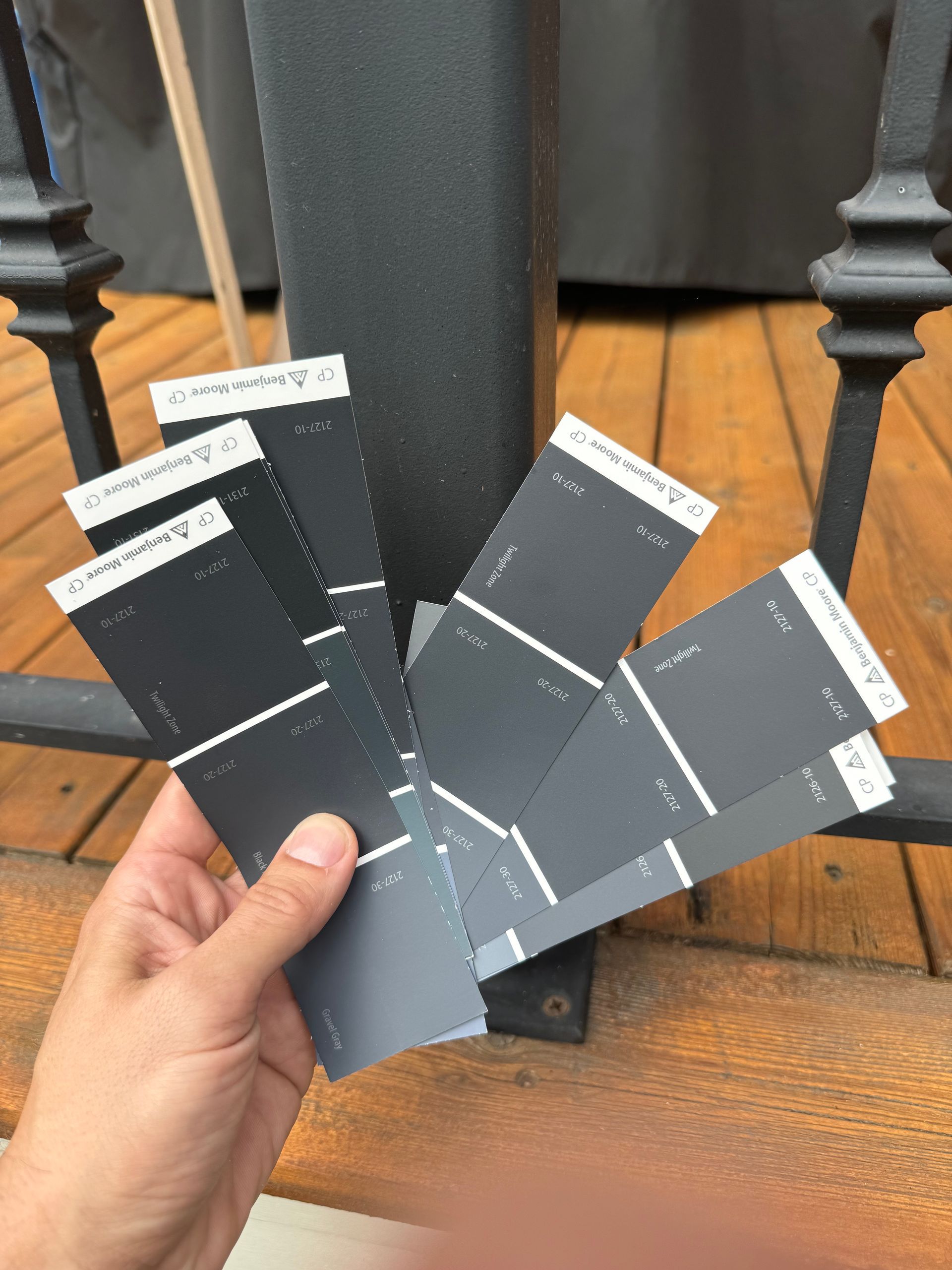 A person is holding a bunch of paint samples in their hand