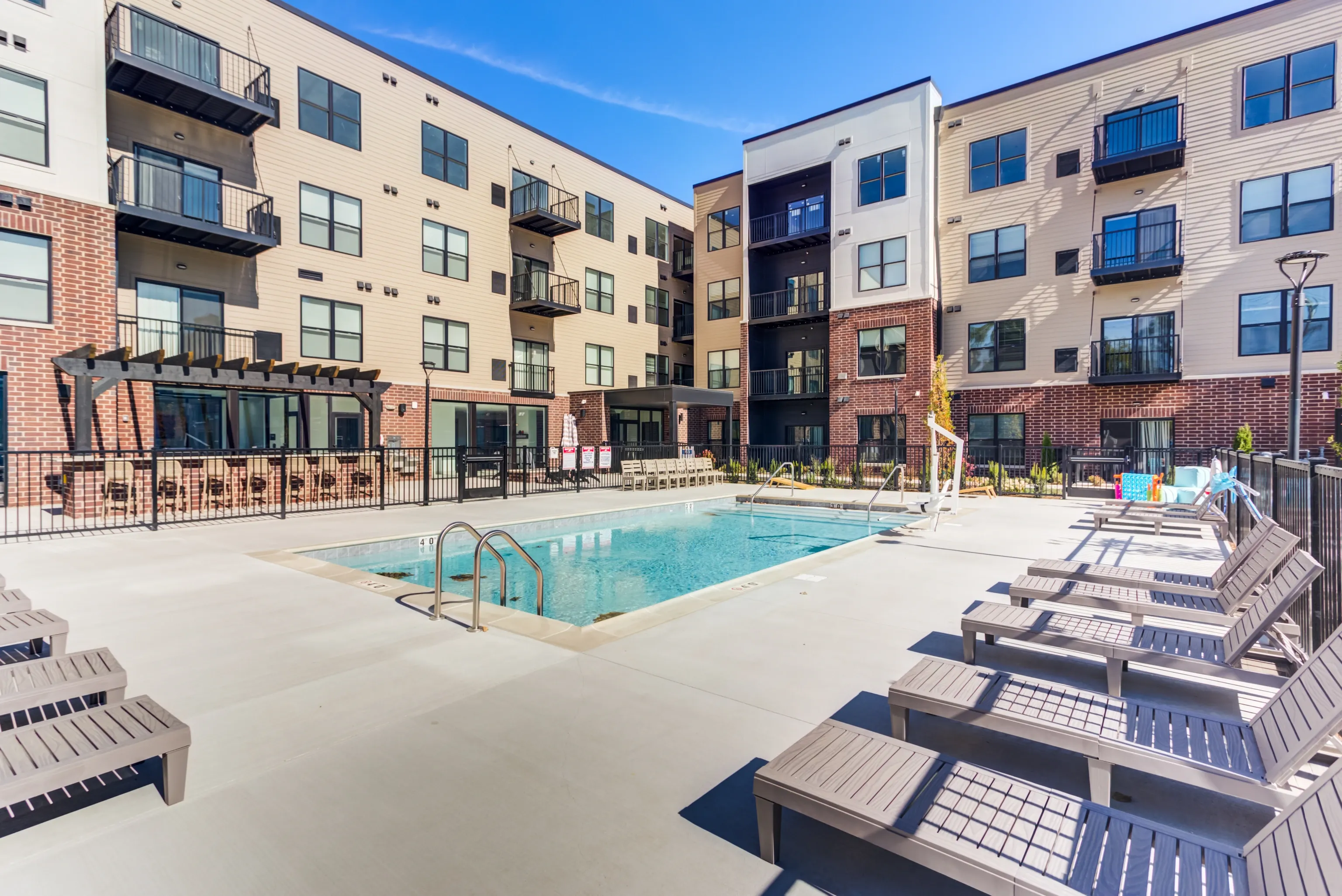 Swimming pool and lounge chairs at apartment complex at Station 250 in Mundelein, IL.