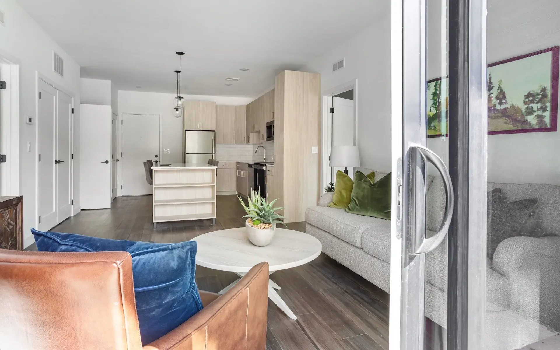 Modern living room with kitchen island and open concept at Station 250 in Mundelein, IL.