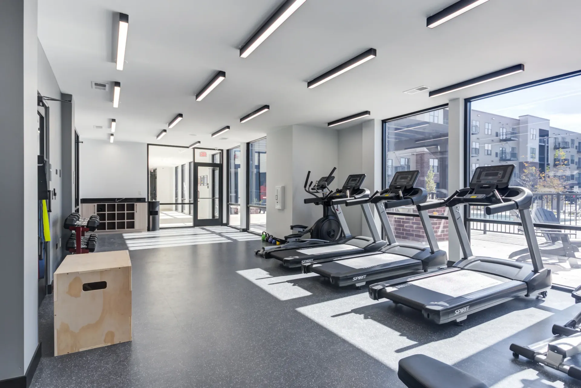 Treadmills and cardio equipment in a modern apartment complex gym.