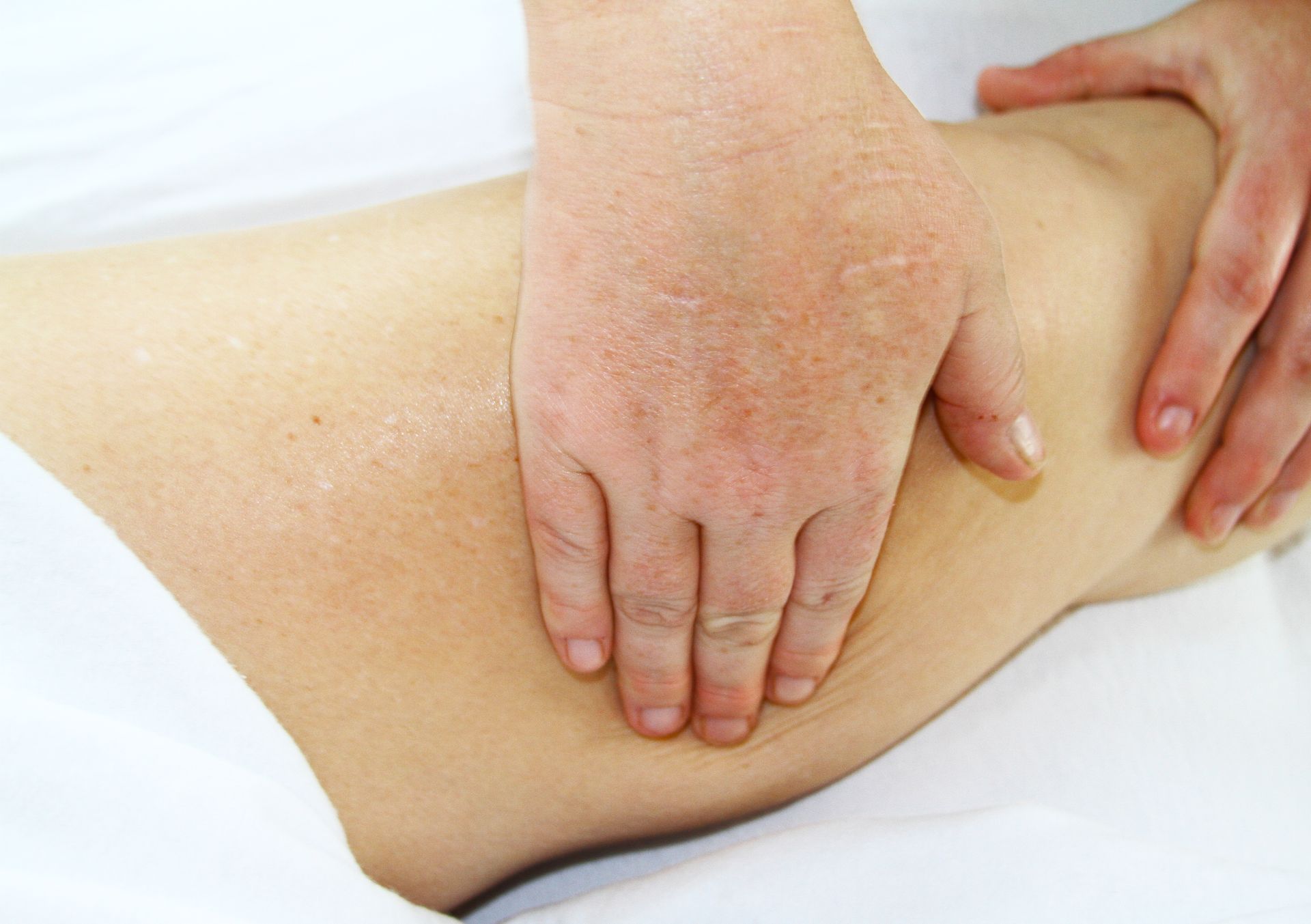 a person is getting a massage on their leg at A Touch of Recovery in Plymouth, MI