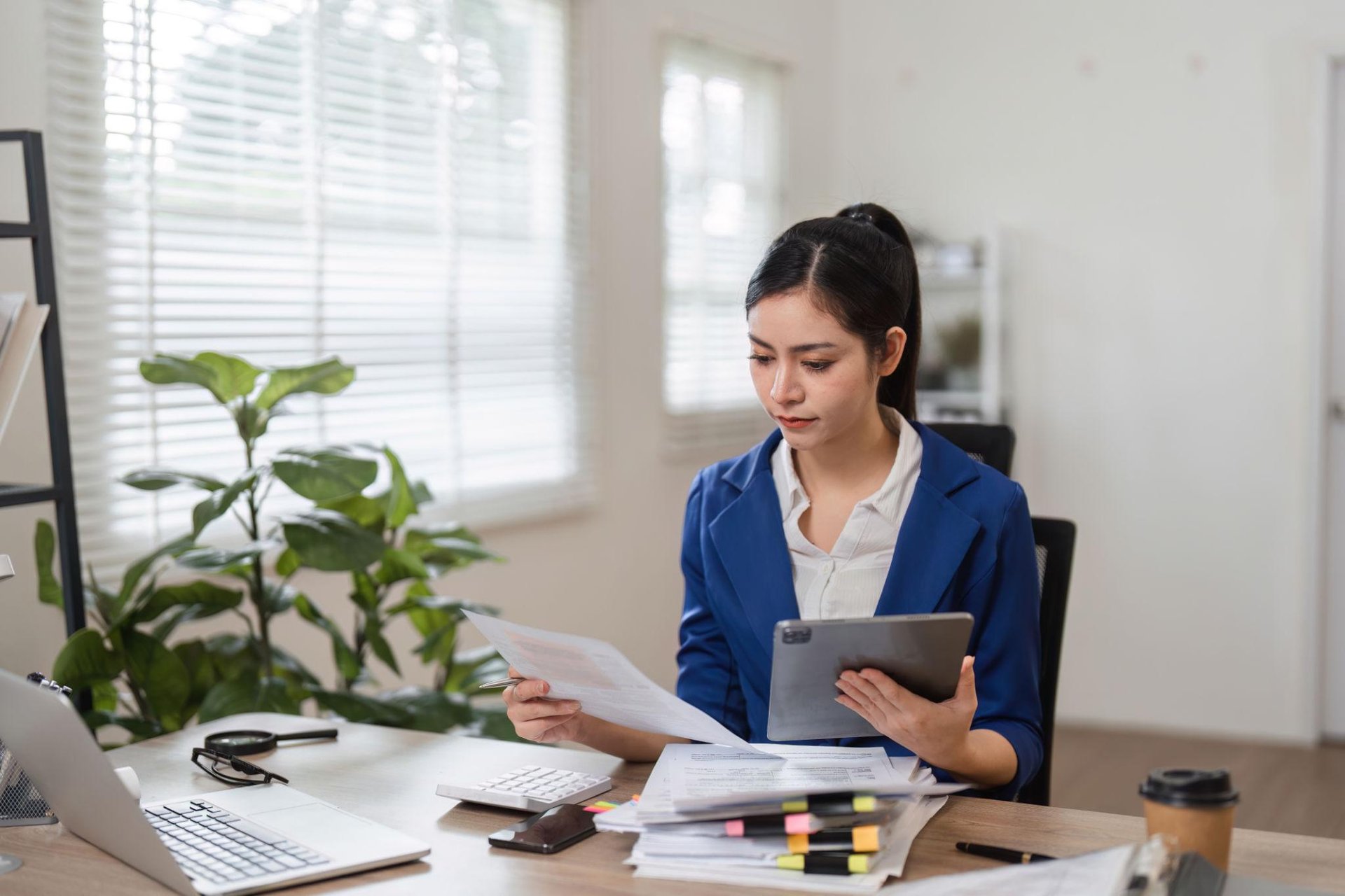 Small business accounting and bookkeeping workspace with financial documents and calculator
