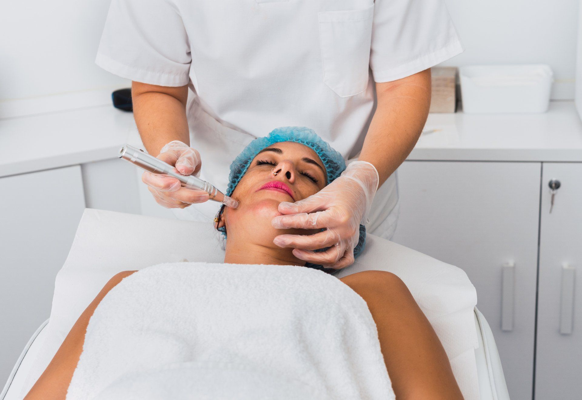 Woman receiving microneedling treatment