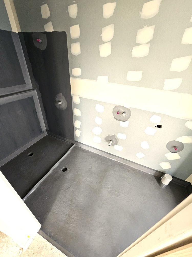 A Bathroom Under Construction With a Gray Floor and White Walls — Legend Waterproofing In Nords Wharf, NSW