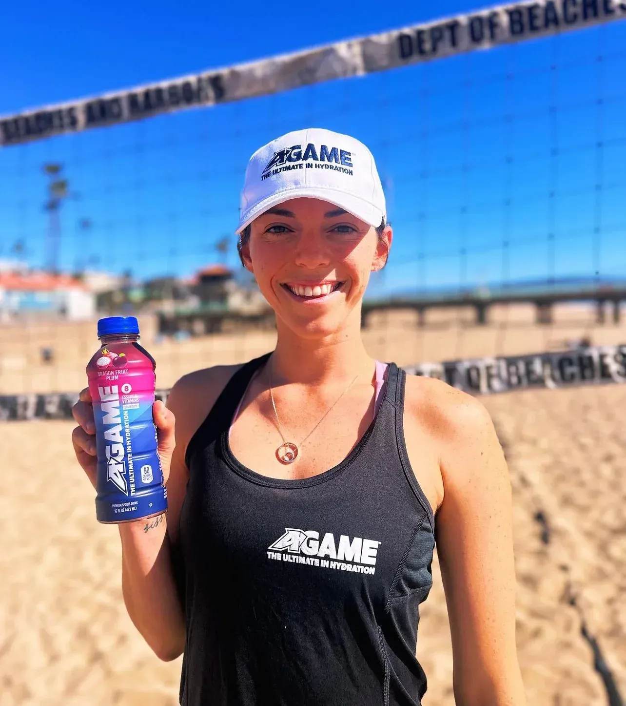A woman wearing a tank top that says agame on it