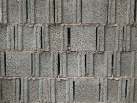 Close-up of gray concrete blocks with a rough, textured surface pattern