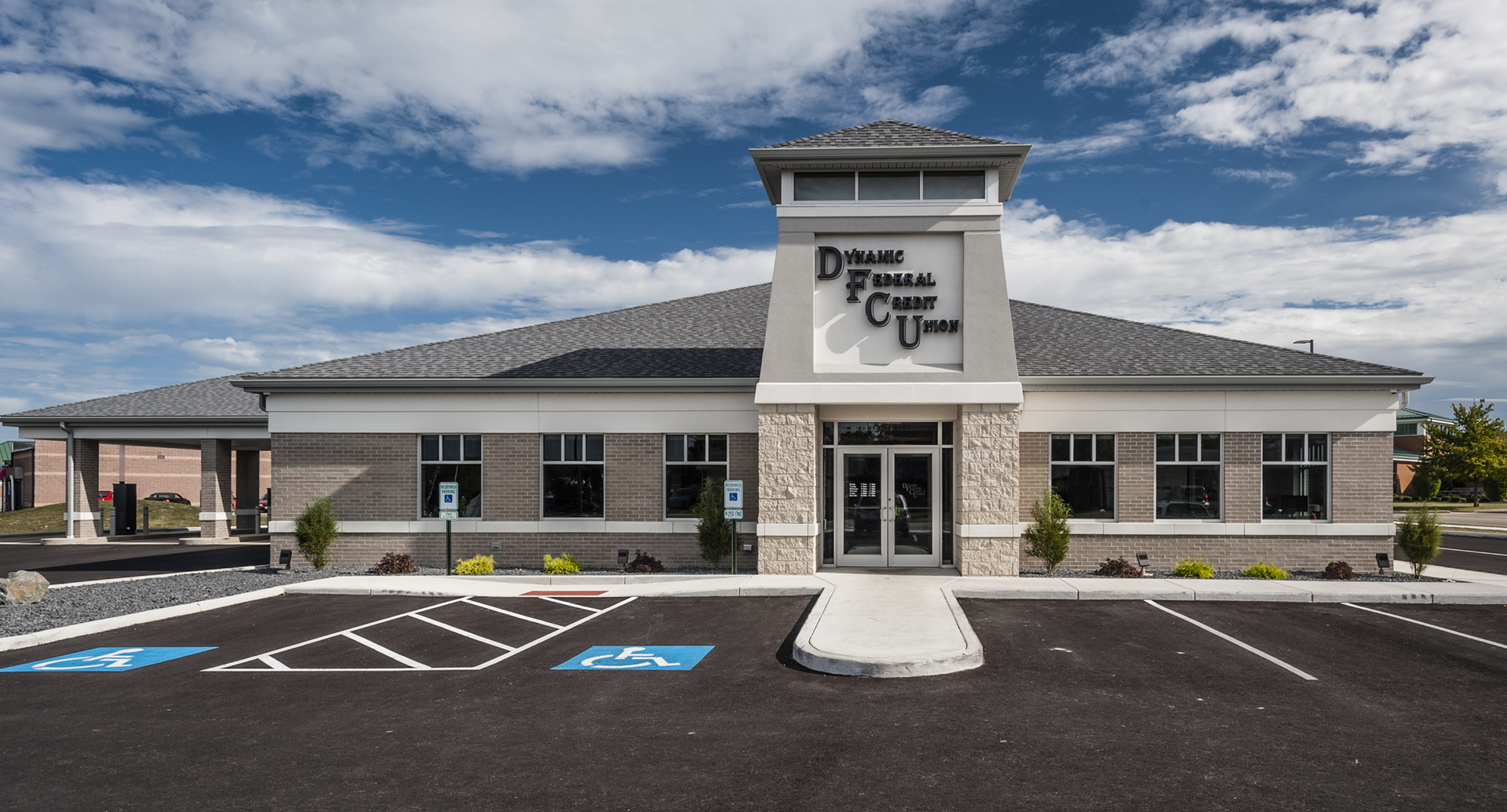 Exterior of Delmar Financial Credit Union building with blue sky.