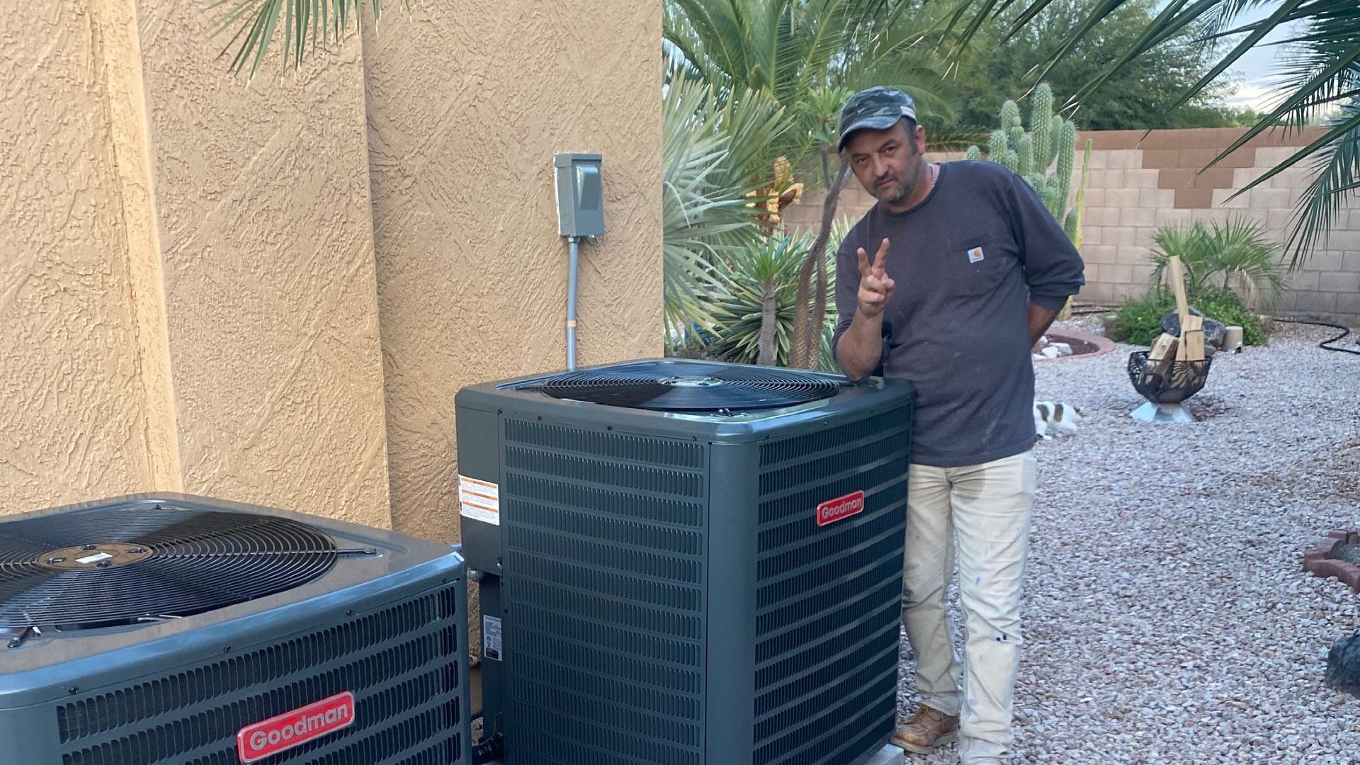 Client posing beside an AC system