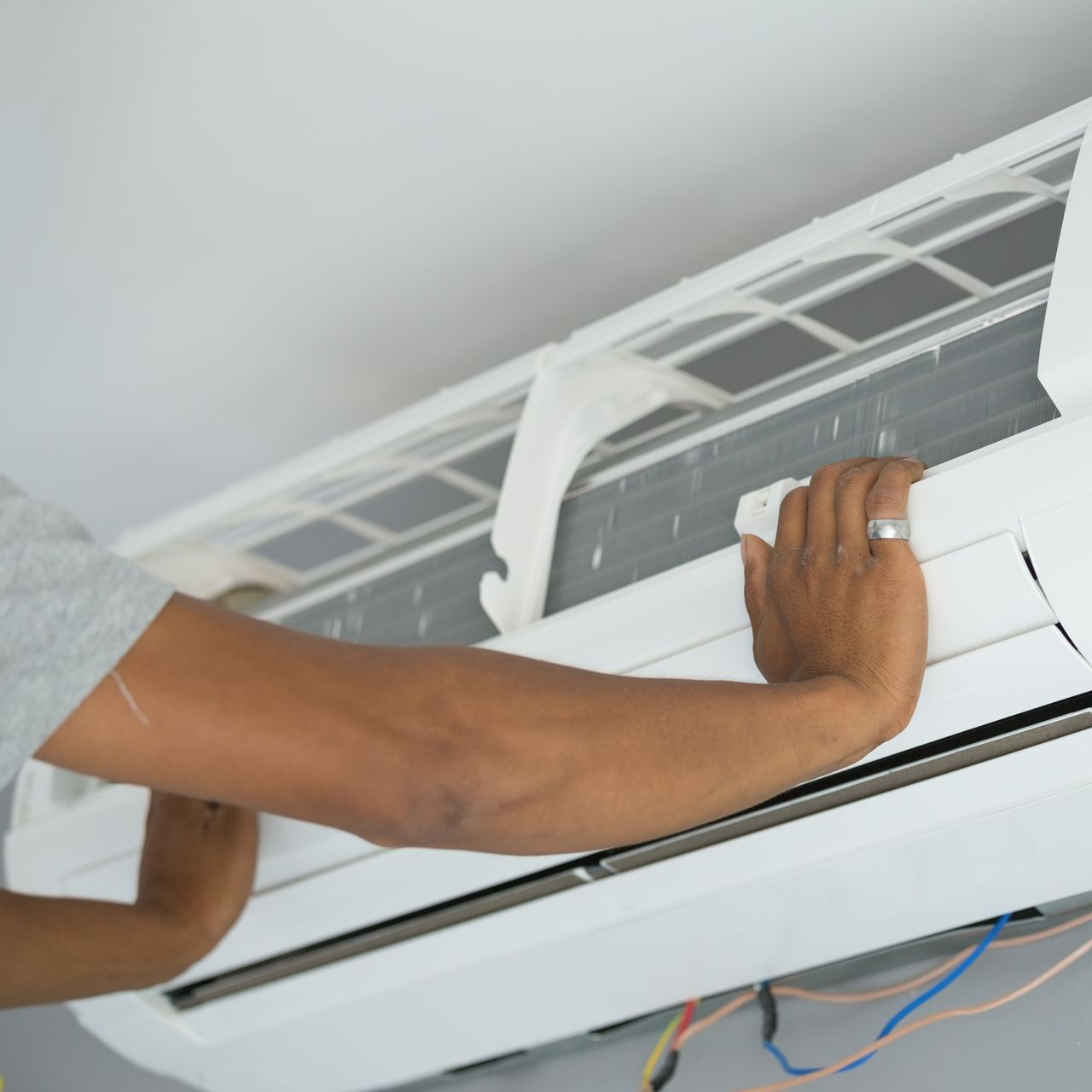 Furnace and water heater in a utility room. Gray metal appliances against white walls.
