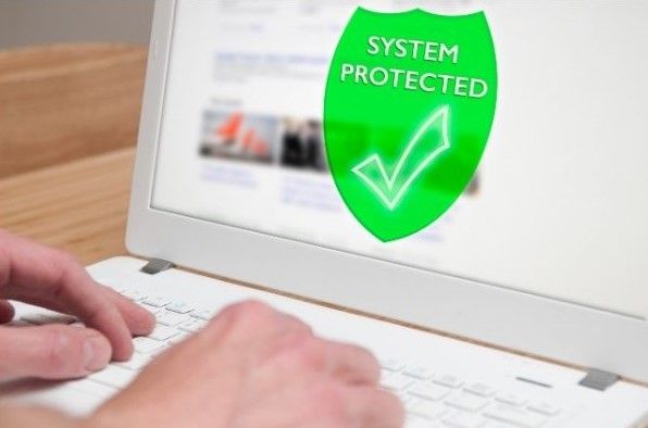 Picture of a Computer Technician working on a white laptop that says 