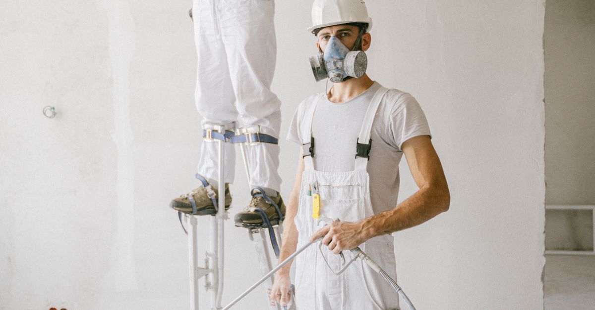 Contractor reviewing plans inside a home renovation