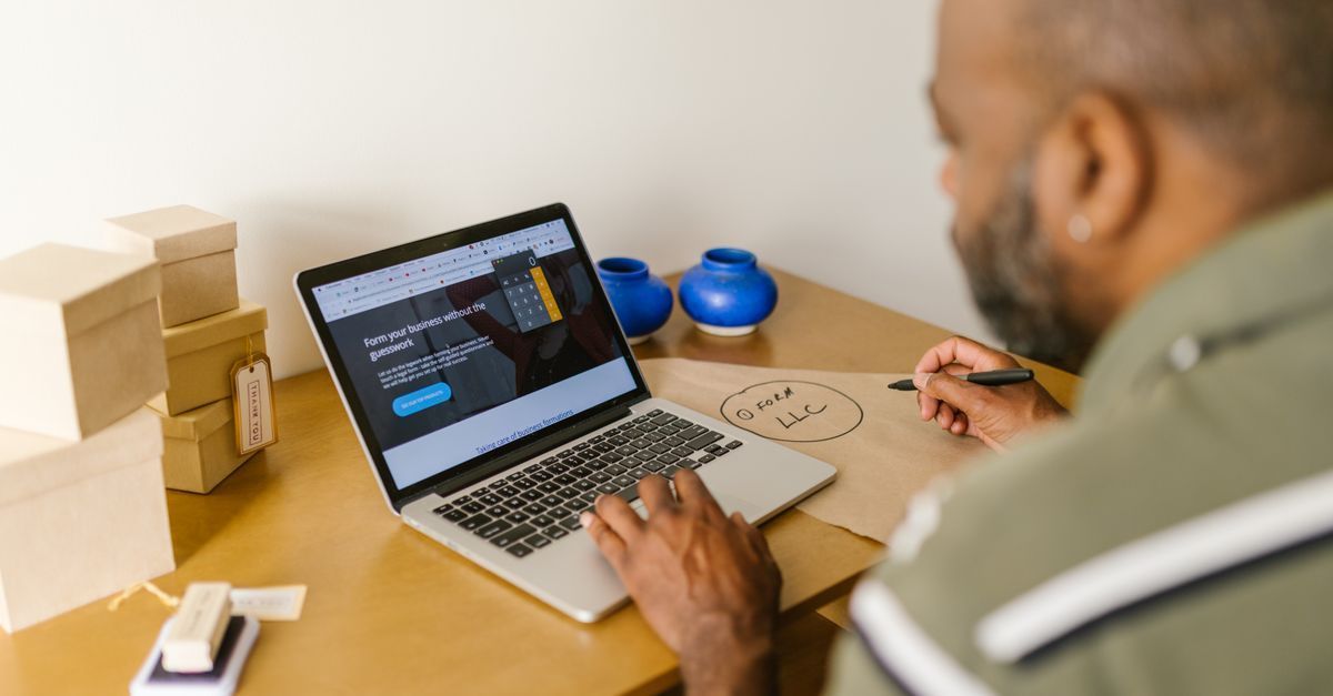 Small business owner planning a new website on a laptop