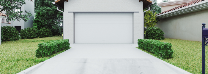 A white garage door is open in the backyard of a house.