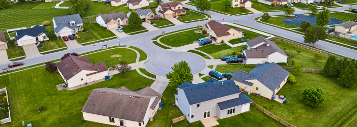 An aerial view of a residential neighborhood with lots of houses and trees.