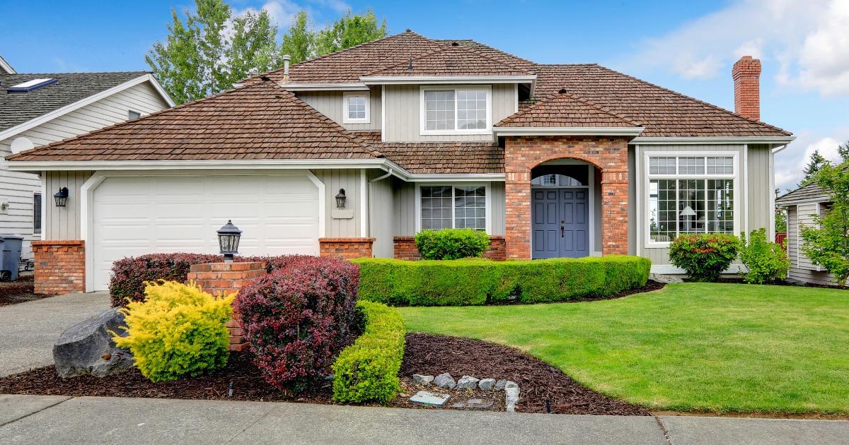 A large house with a large lawn in front of it.