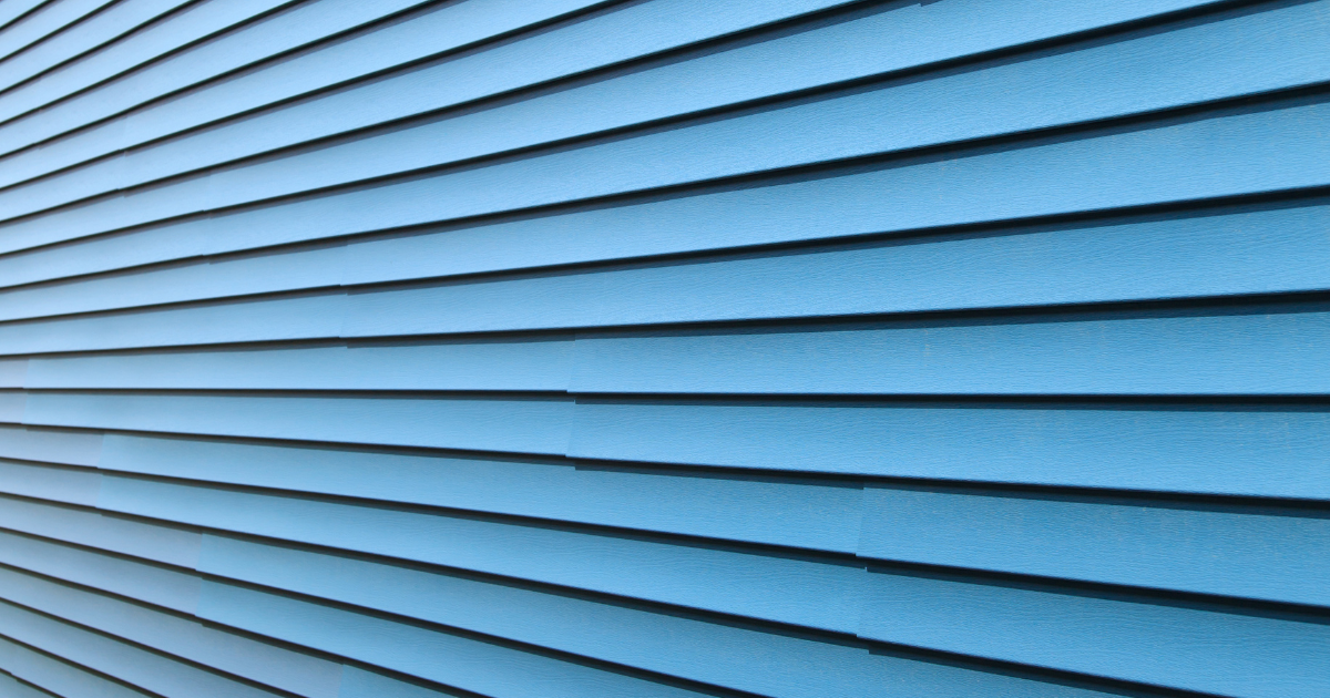 A close up of a blue siding on a building.