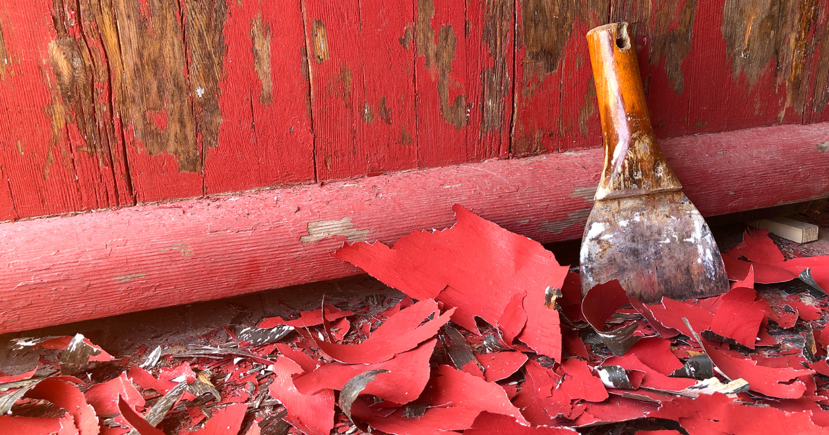 A spatula is sitting on top of a pile of red carpet.