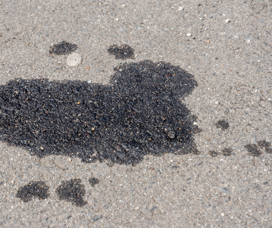 Black oil stain on gray asphalt.