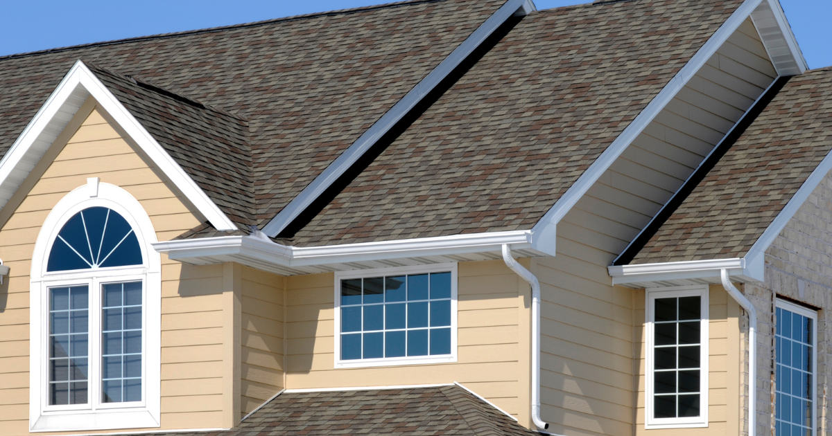 A house with a brown roof and white trim