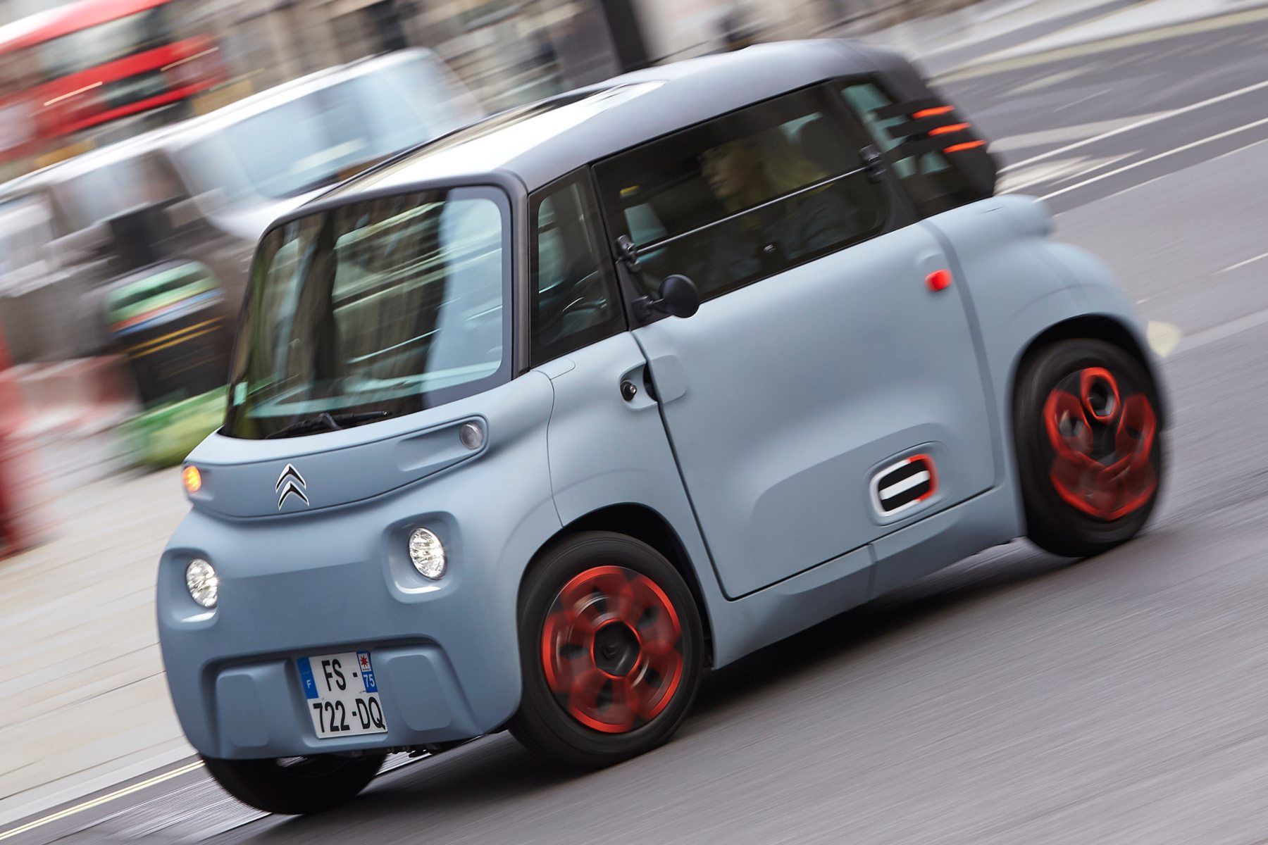 a electric Citroen Ami is driving down a city street