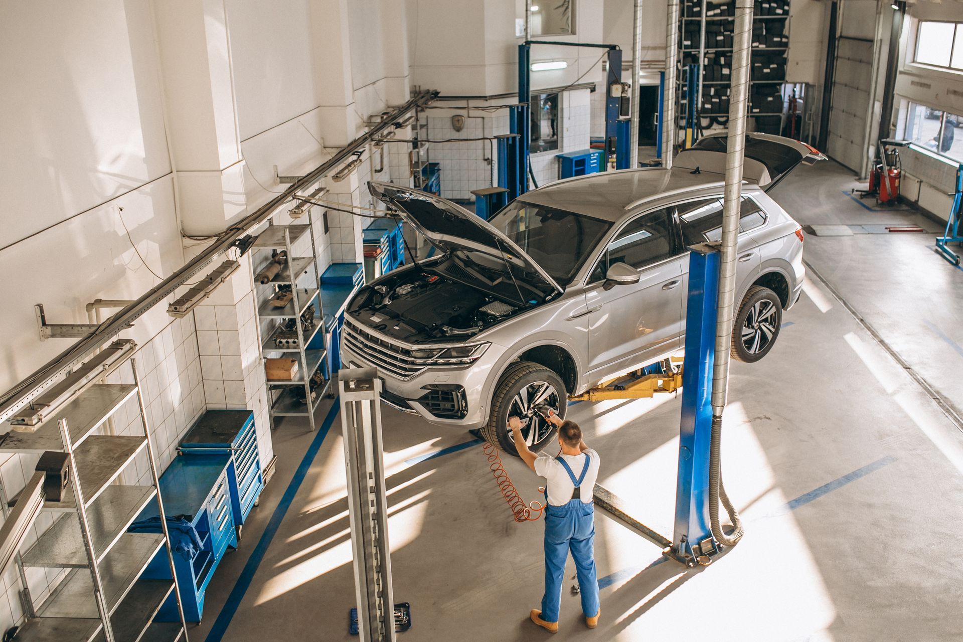 A man working on a car in a garage.