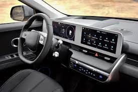 the interior of an electric vehicle with a steering wheel and dashboard