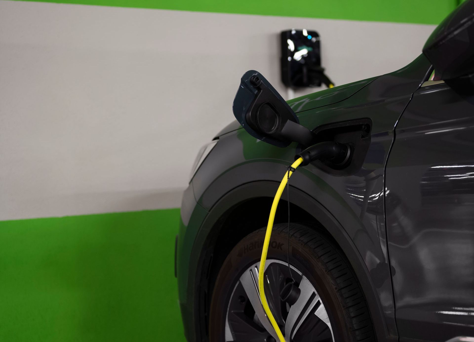An electric car is being charged in a parking garage