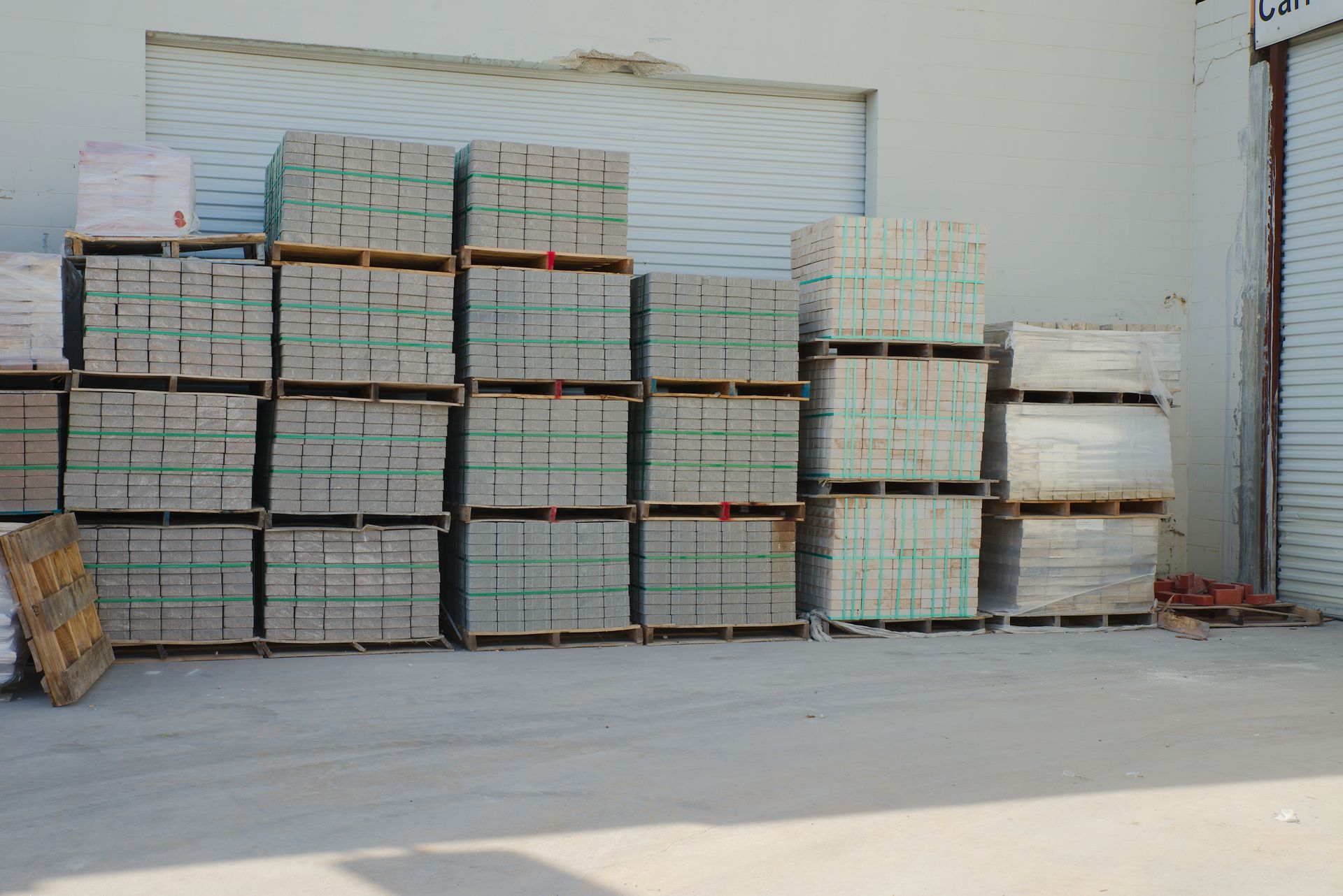 Neatly stacked pale bricks secured with green strapping. Neatly stacked pale bricks secured with green strapping.