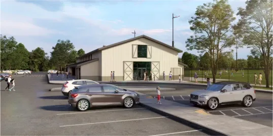 a group of cars are parked in a parking lot in front of CopperPlex field house