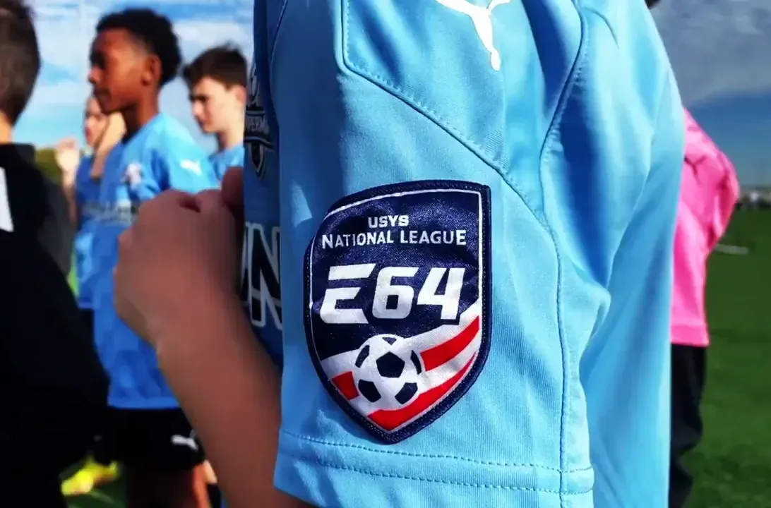 a Coppermine Soccer Club player wearing a soccer jersey with an Elite 64 patch, a Coppermine Soccer Club player wearing a soccer jersey with an Elite 64 patch,