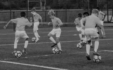 a group of young boys are playing soccer on a field .