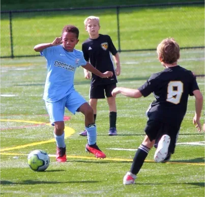 Coppermine Boy soccer player running with ball