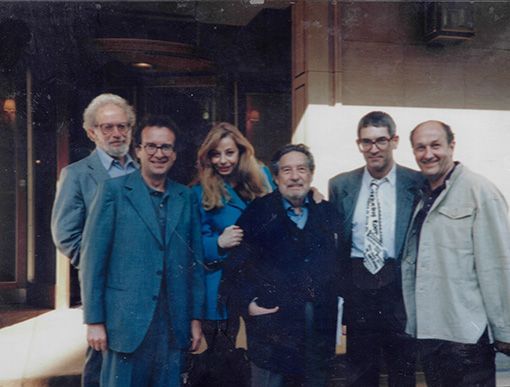 A group of people posing for a picture in front of a building