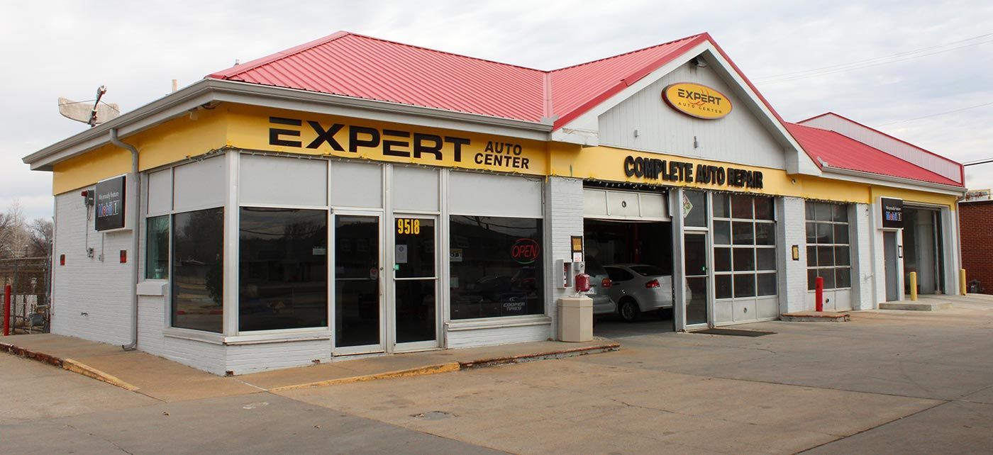 Expert store exterior with red roof and large front windows on a street corner.