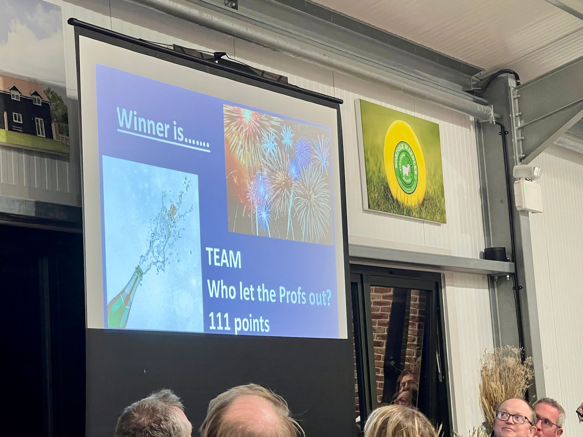 A presentation screen displays winners: 