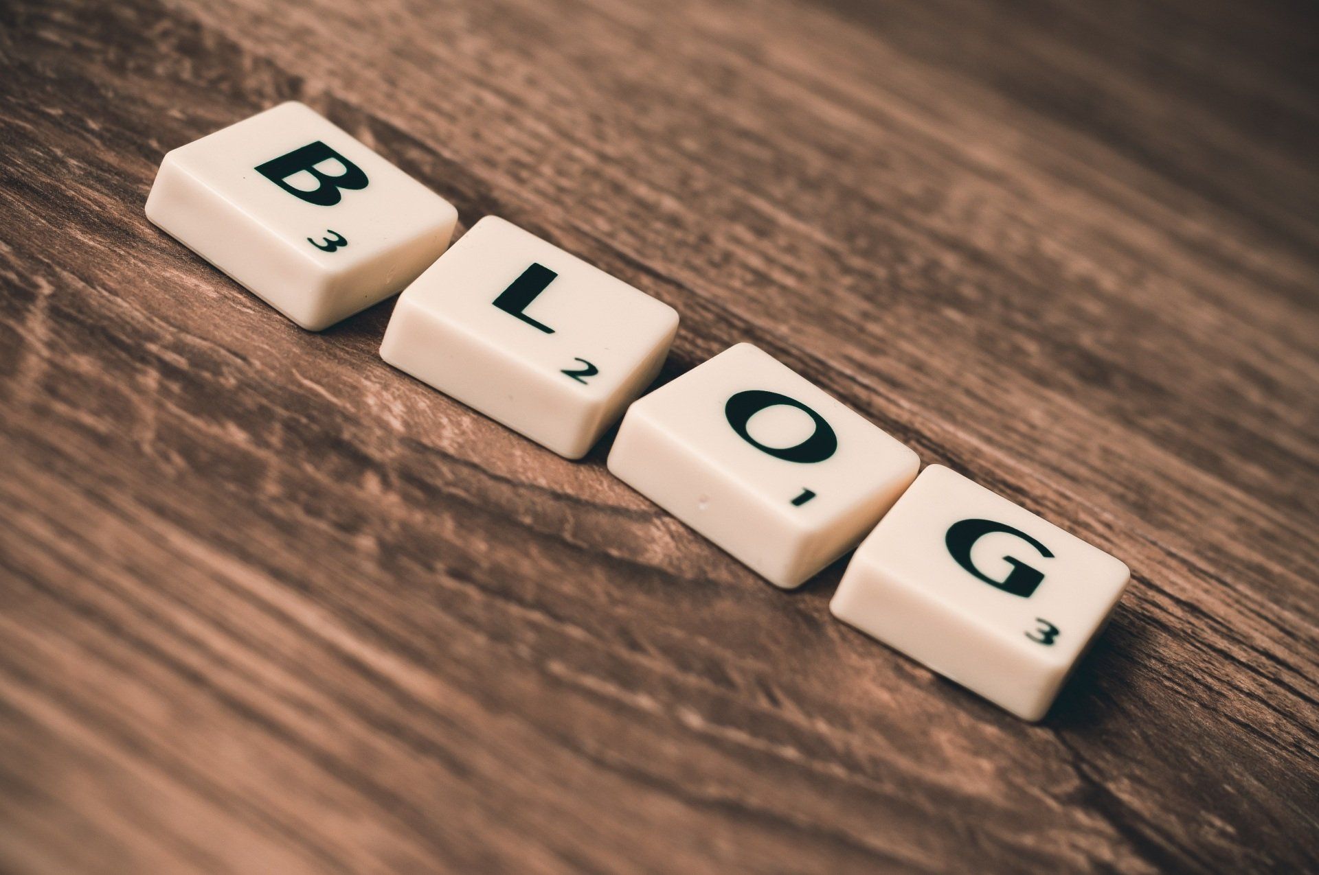 Wooden blocks spelling “BLOG” on a rustic wooden surface.