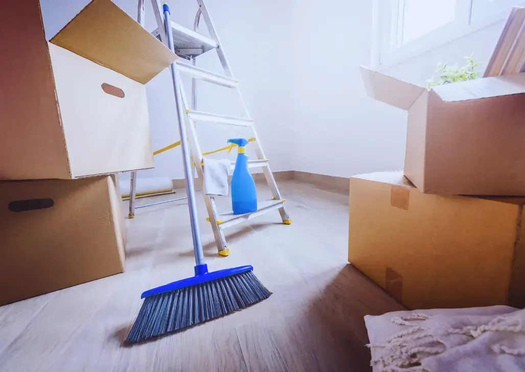 Office Cleaning Services Las Vegas-Three cleaning staff in blue aprons on stairs, one carrying supplies, one mopping, and one vacuuming.