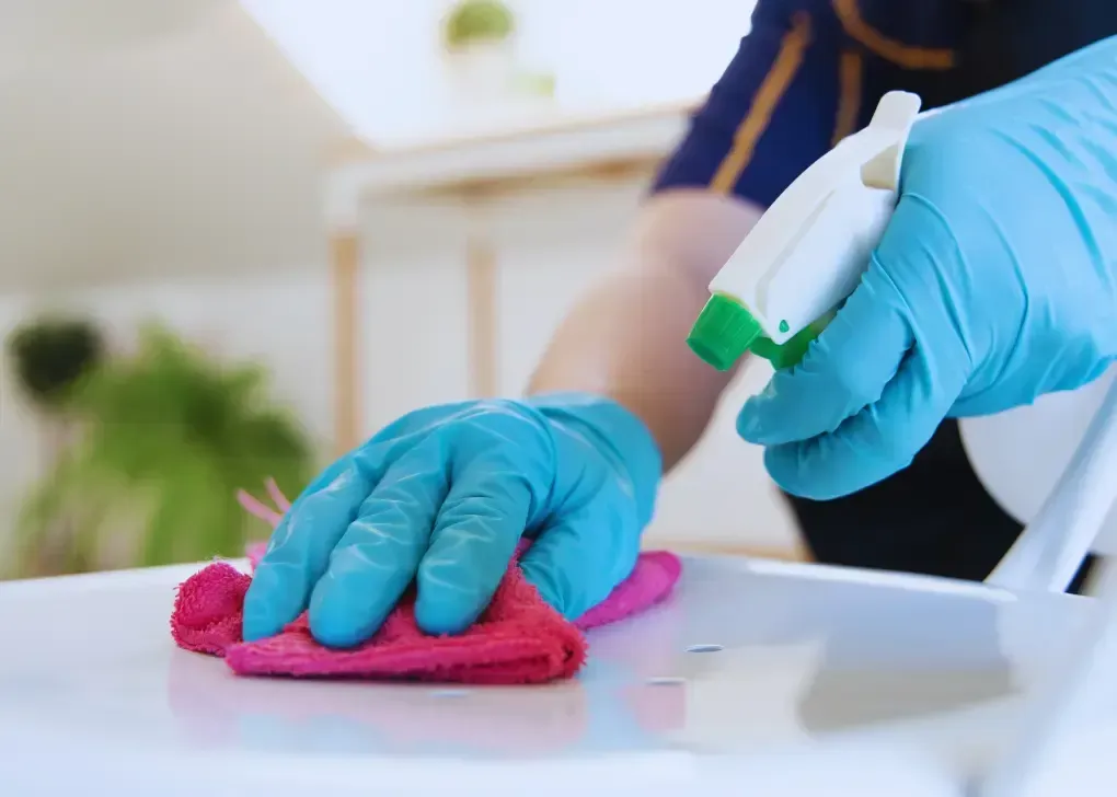 wiping table with pink cloth