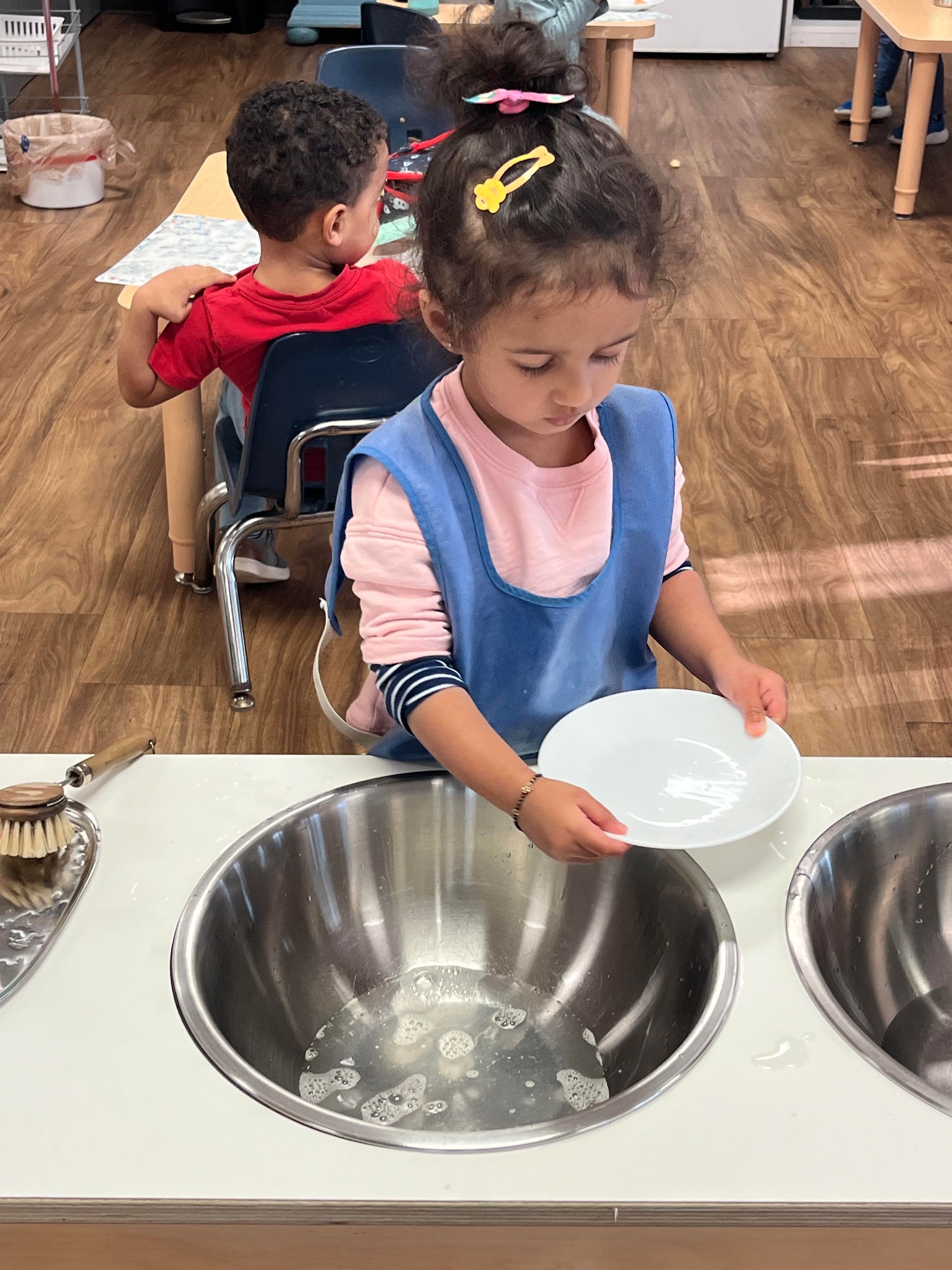 Child washing dishes practical life toddler