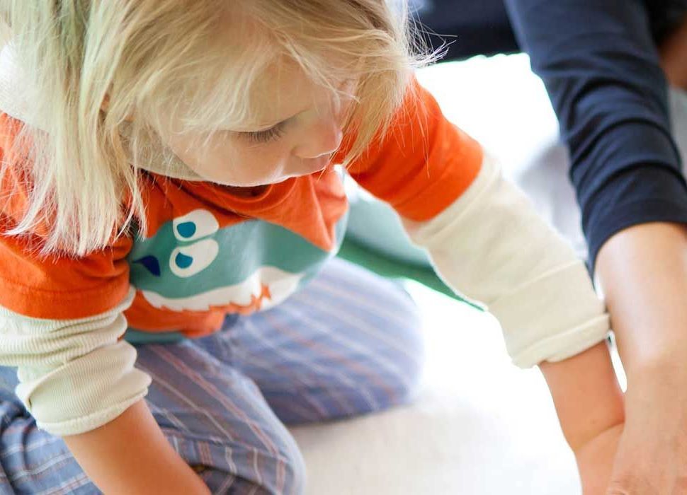 Montessori child and guide working in the classroom