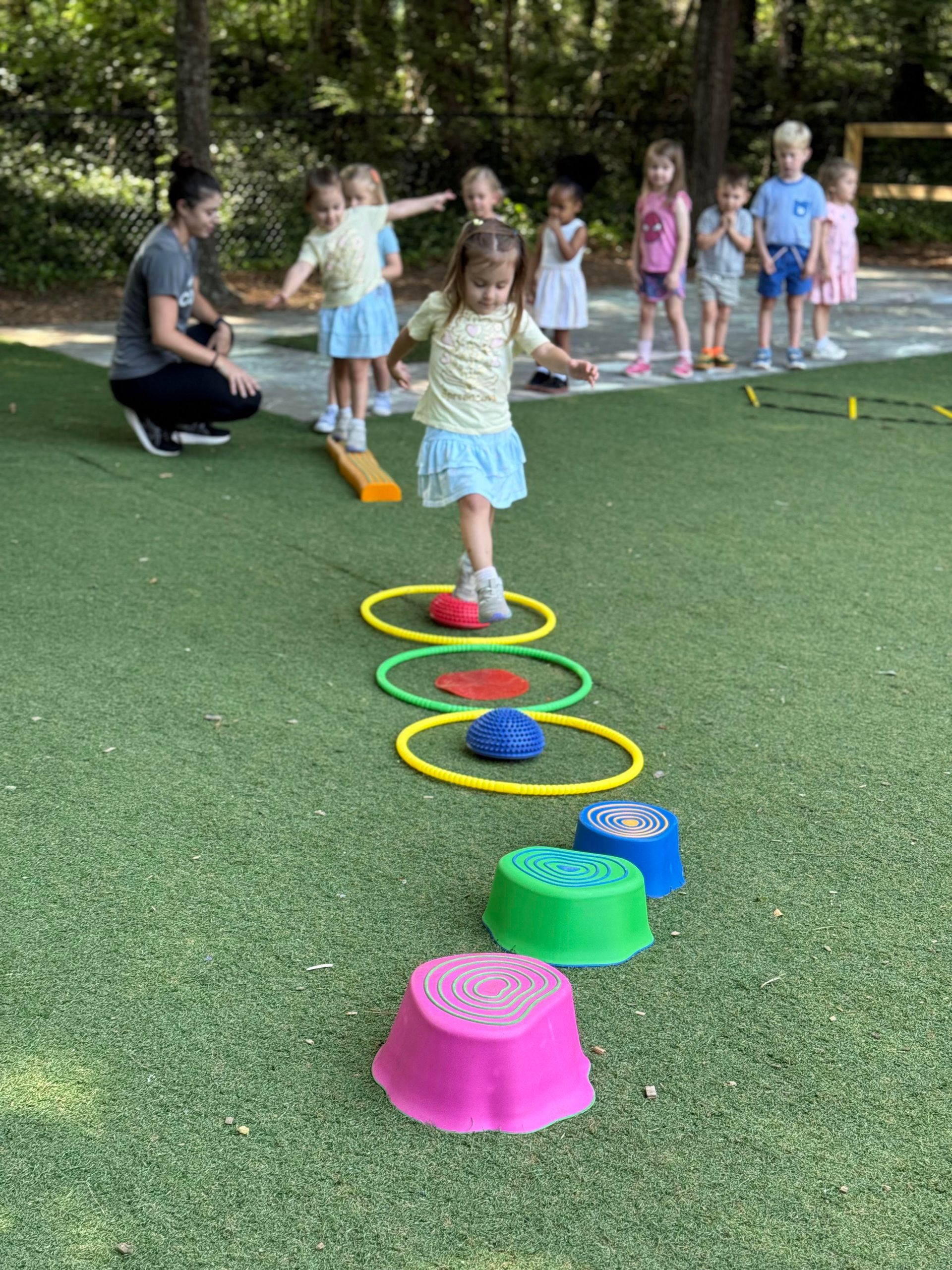 Montessori guide and children balance gross motor movement exercise