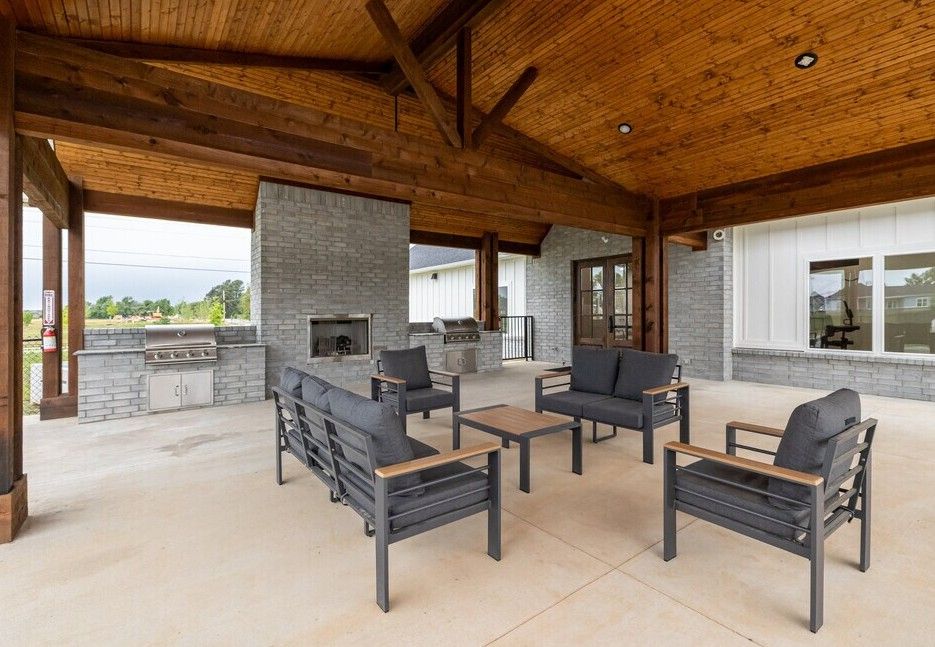 There is a fire pit in the middle of the patio area.