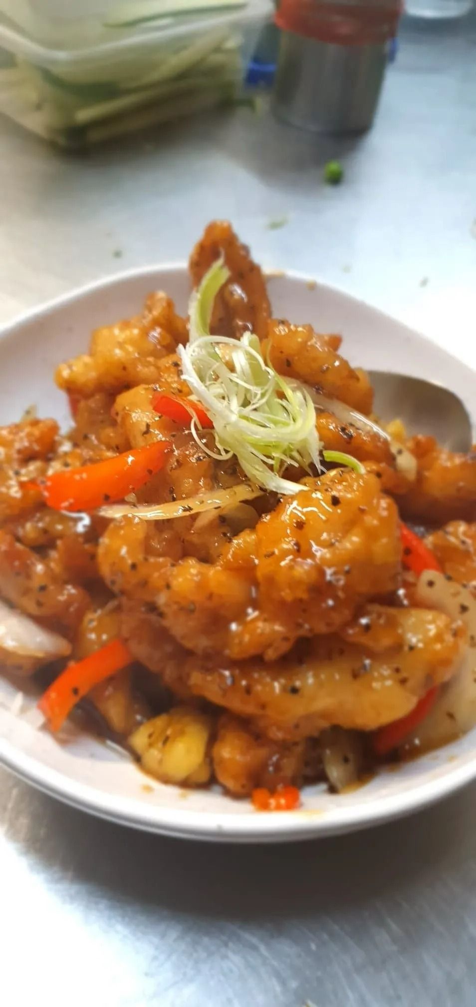 A White Bowl Filled With Orange-glazed Fried Food — L'il Buddha Asian Cuisine in Salamander Bay, NSW