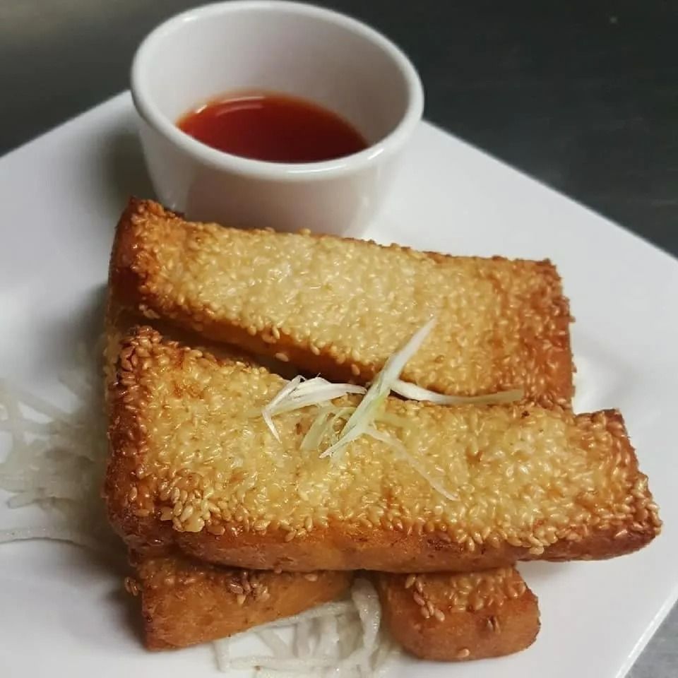 Golden Sesame-covered Shrimp Toast With Dipping Sauce on a White Plate — L'il Buddha Asian Cuisine in Salamander Bay, NSW