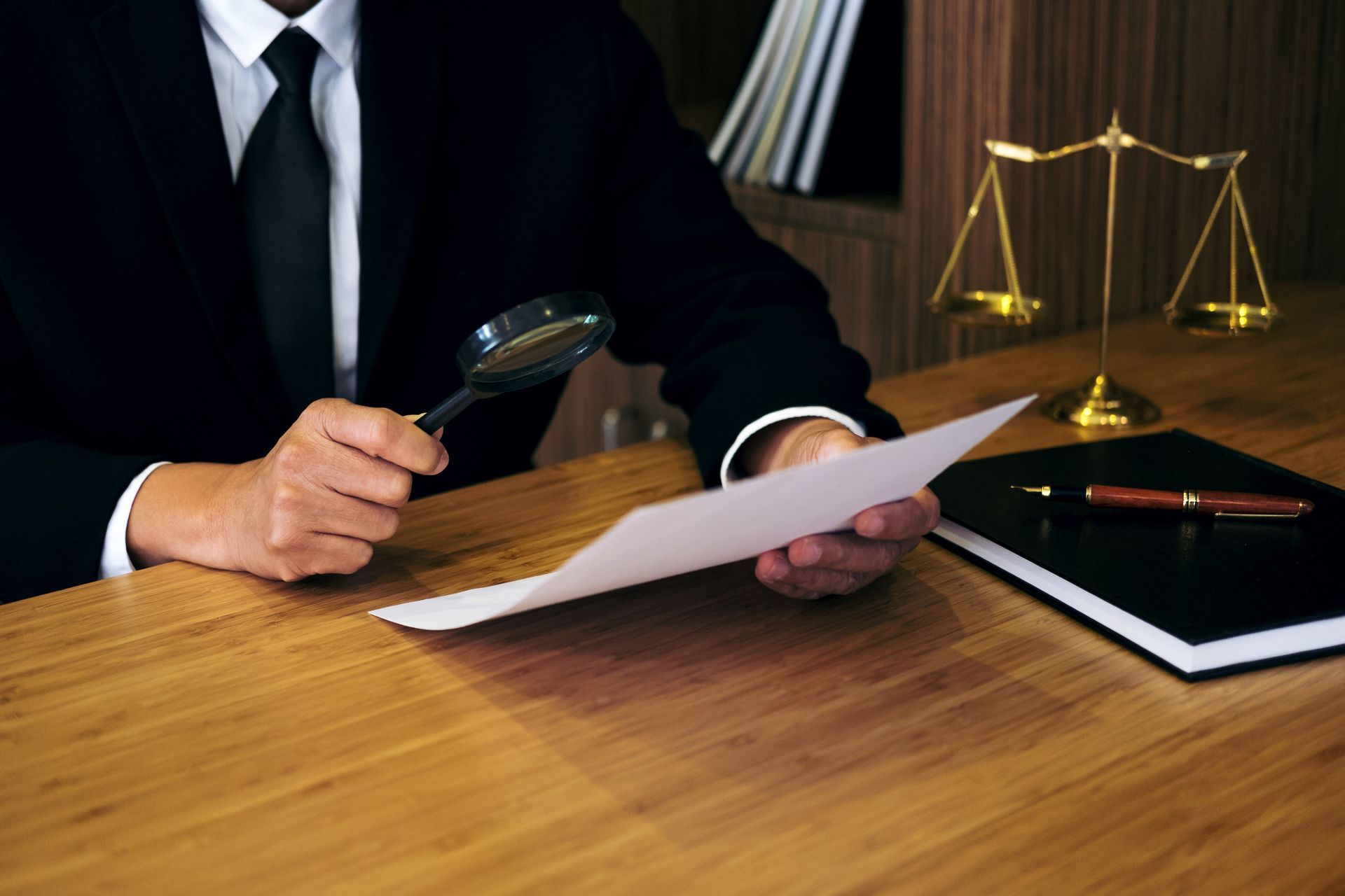 Lawyer reviewing documents showcasing a brain injury lawyer examining contracts in court setting.