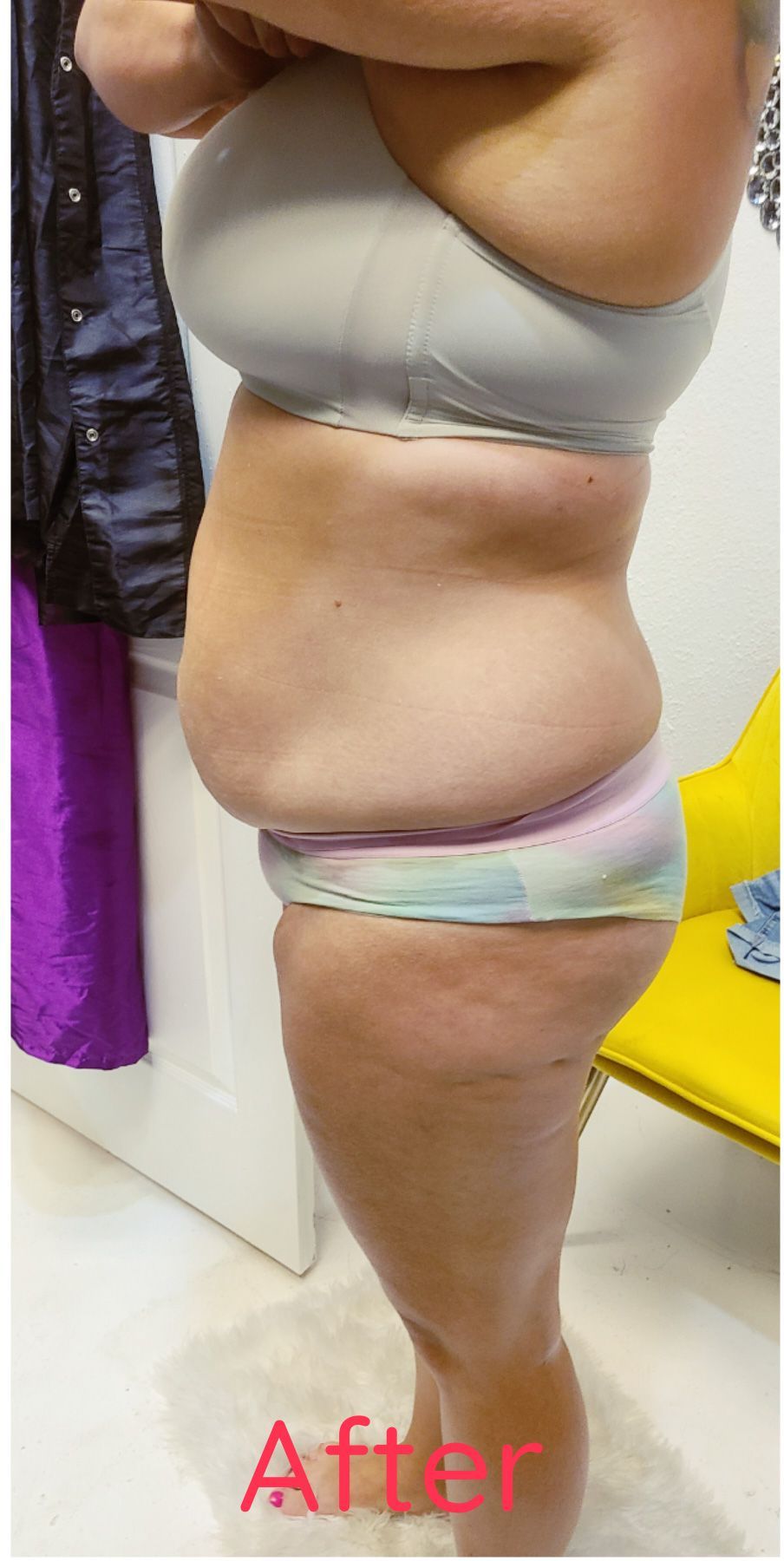 A woman in a bra and underwear is standing in a room.