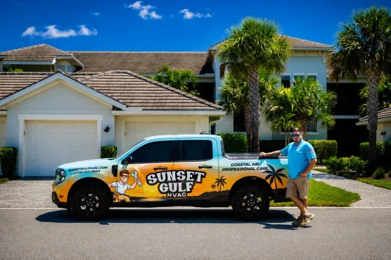 Bryan, owner of Sunset Gulf HVAC, standing next to his wrapped service truck in a Southwest Florida neighborhood.