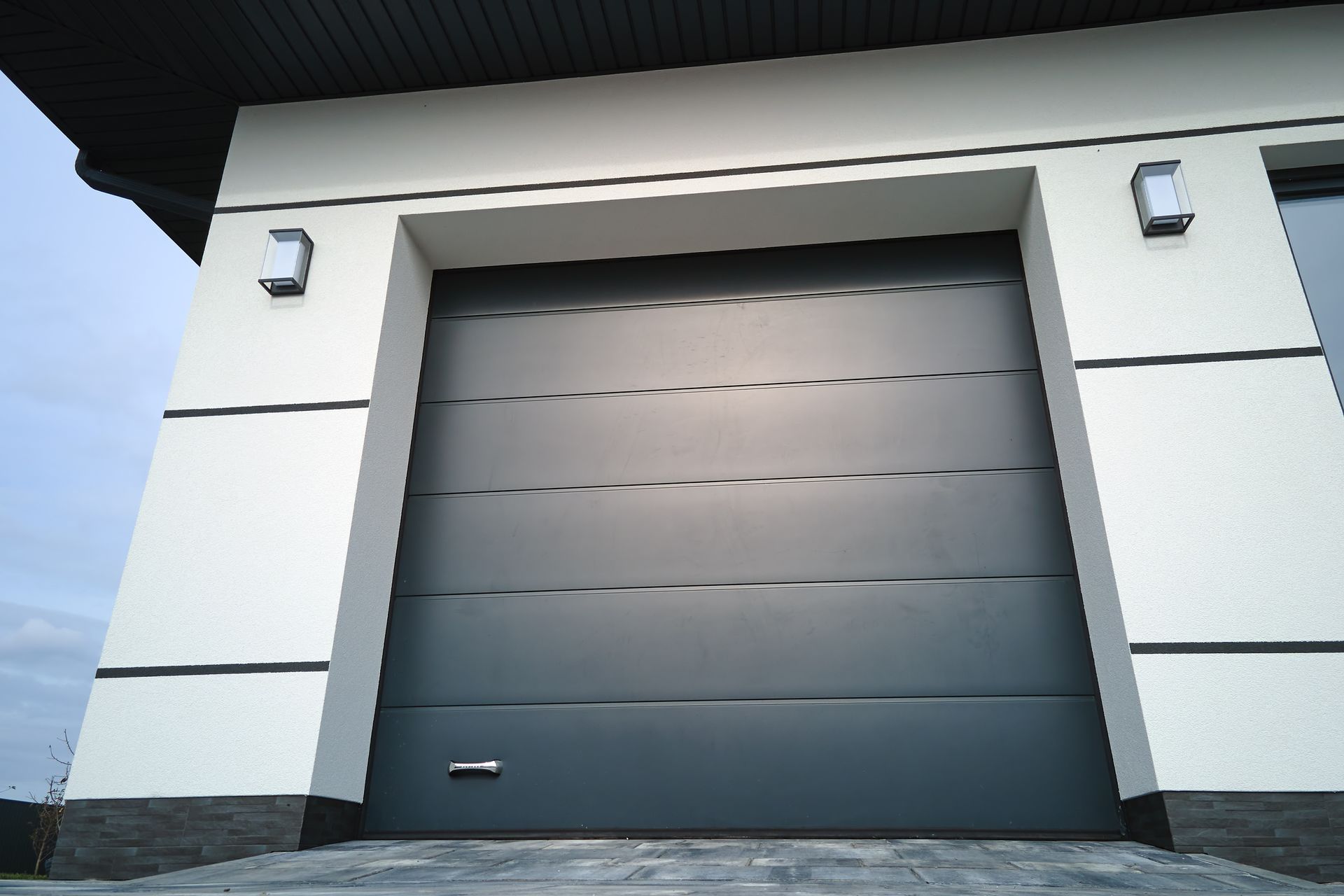 Automatic electric roll-up commercial garage gate or push-up door in modern private building ground floor 