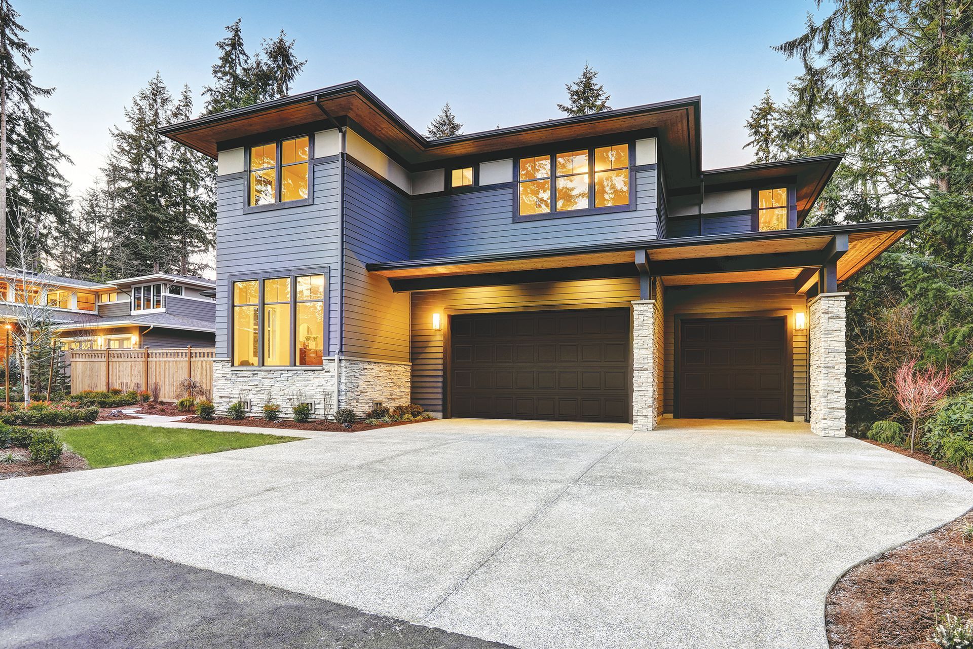 A large white barn with a lot of garage doors and windows.