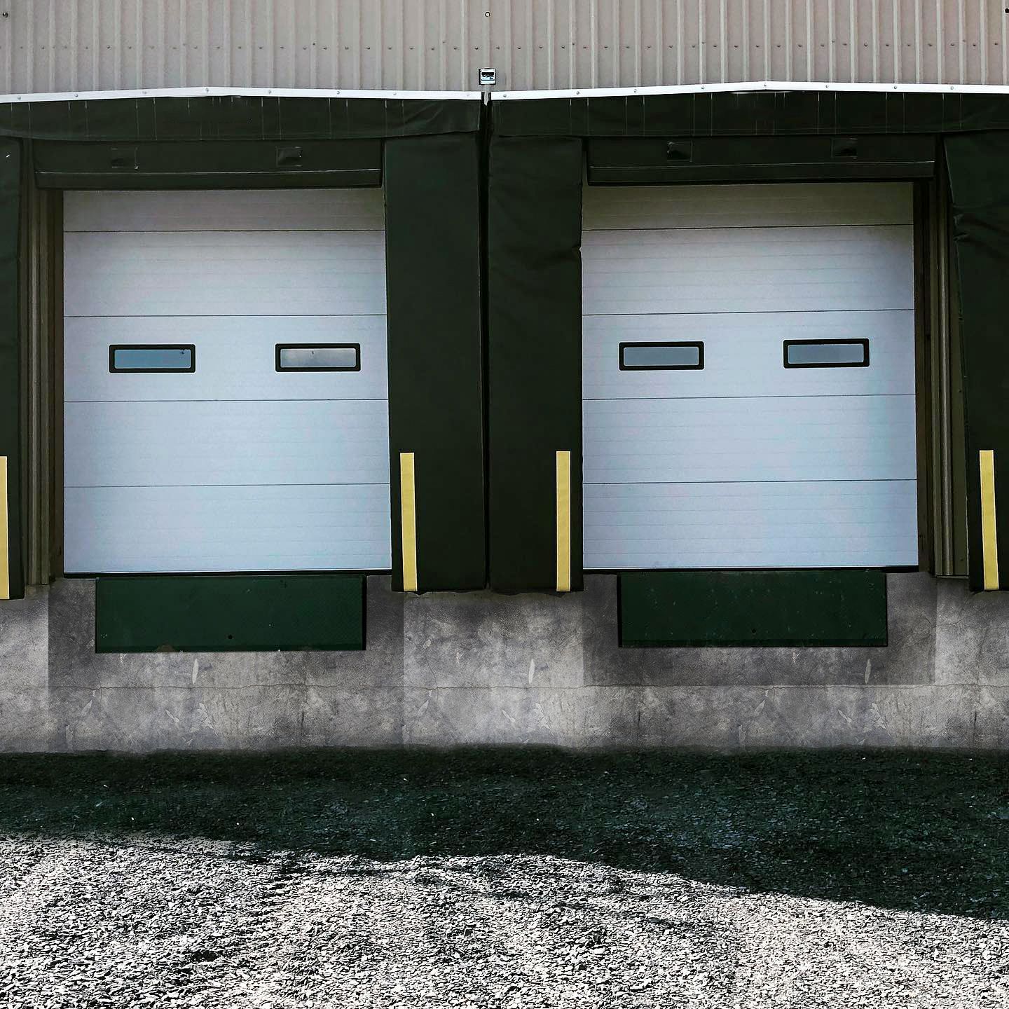A couple of loading doors on the side of a building.